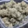 Bulk White Widow cannabis buds covered in thick white trichomes.